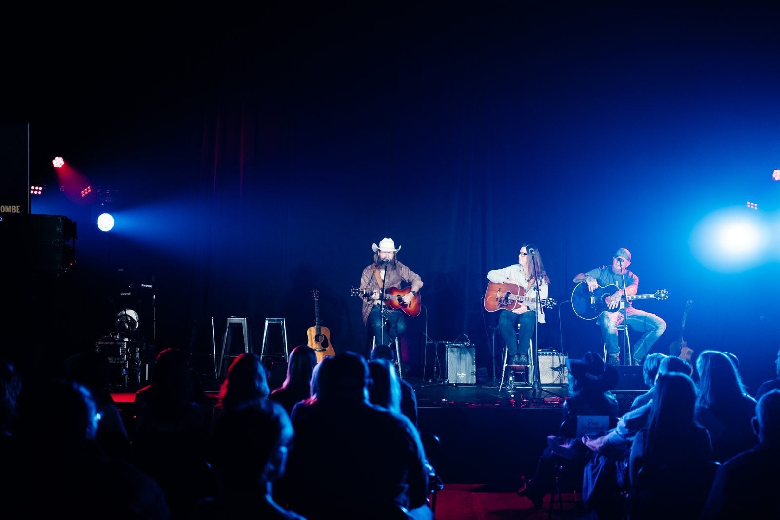 Artists performing together on stage at an Unsung Hero benefit concert